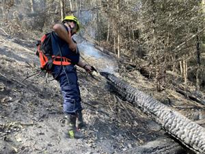 Z důvodu nepřístupnosti terénu museli hasiči k dohašování terénu využívat pouze vaky s vodou, které nosili na zádech. 
FOTO: TOMÁŠ KOUŘIL